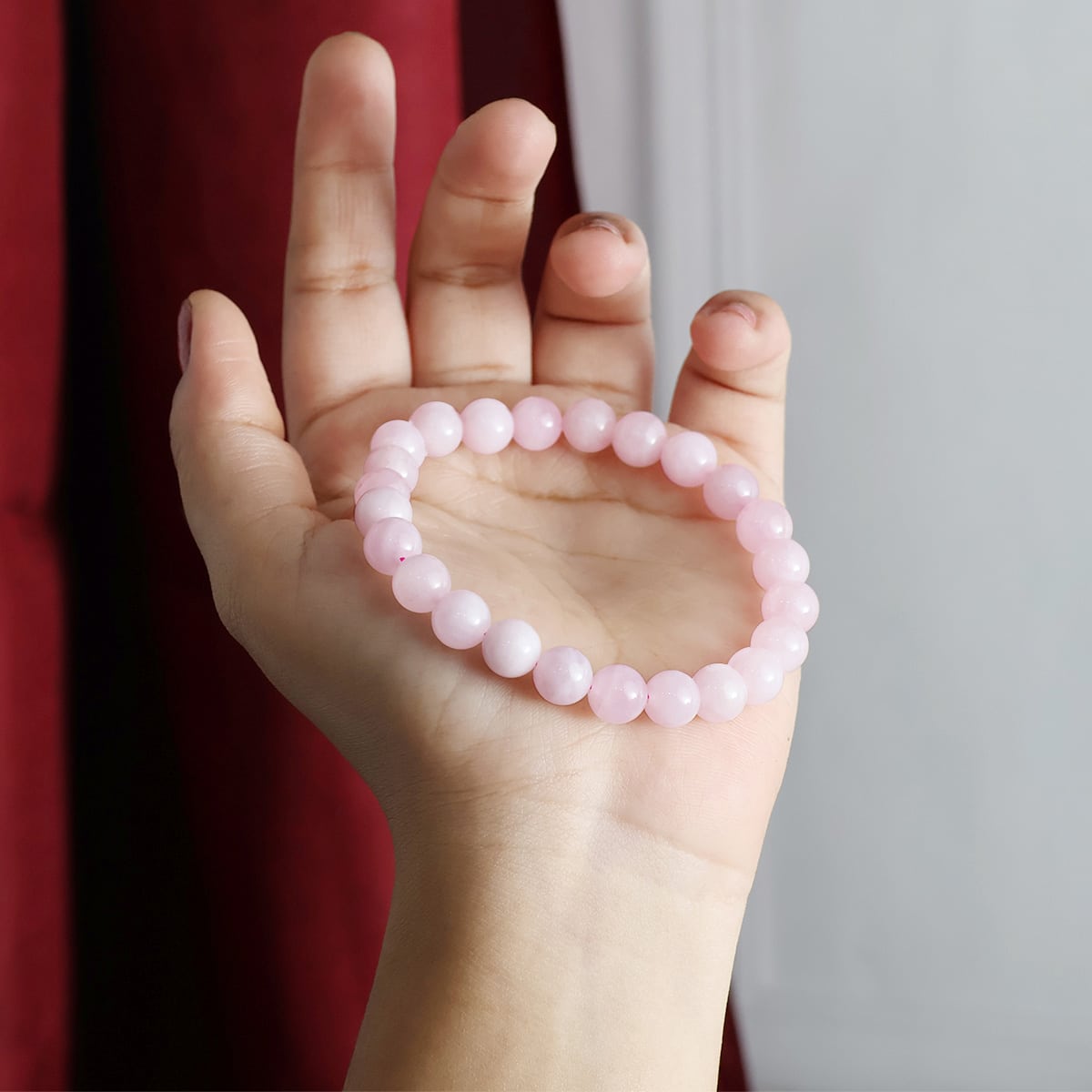 A beautiful Rose Quartz Round Beads Bracelet showcasing natural pink crystals, perfect for emotional healing and self-love.
