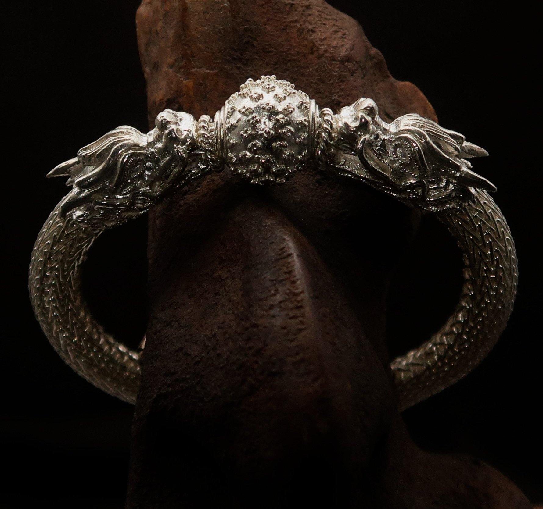 Handcrafted sterling silver bracelet featuring two dragon balls, showcasing intricate design and quality craftsmanship.