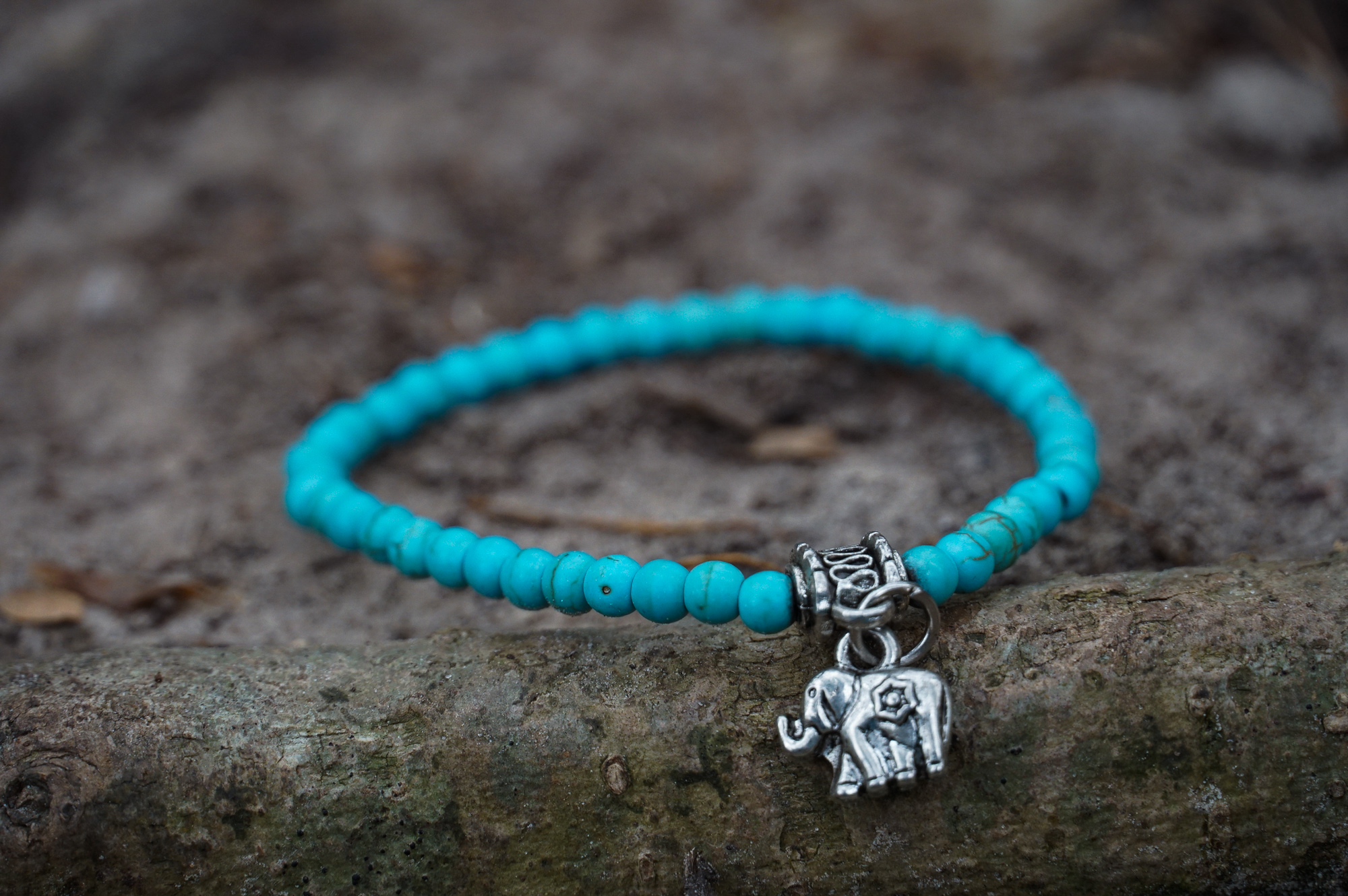 Turquoise Boho Elephant Elastic Bracelet featuring vibrant beads and brass elephant charms, handmade by Thai artisans for a unique bohemian style.