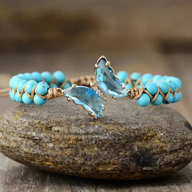 A handcrafted turquoise crystal butterfly bracelet featuring intricate butterfly details, showcasing elegance and calming energy.