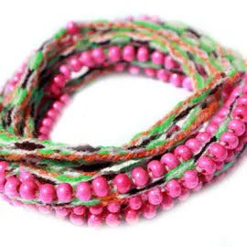 Washed Out Hot Pink Beaded Tie Wraps featuring handwoven alpaca blend textile and Czech beads, styled as a bracelet, anklet, and choker.