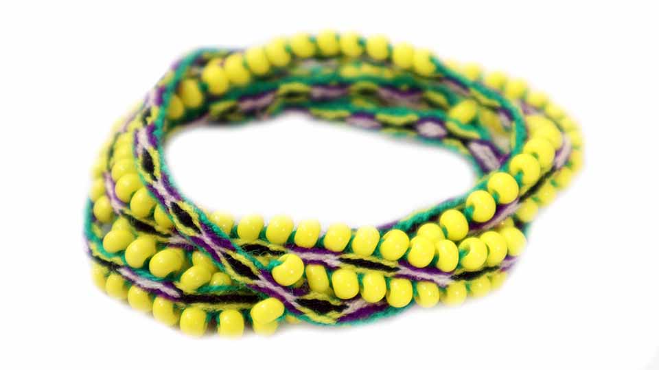 Washed Out Tie Wraps featuring yellow, true green, and matte purple colors with handwoven alpaca blend textile and Czech glass beads.