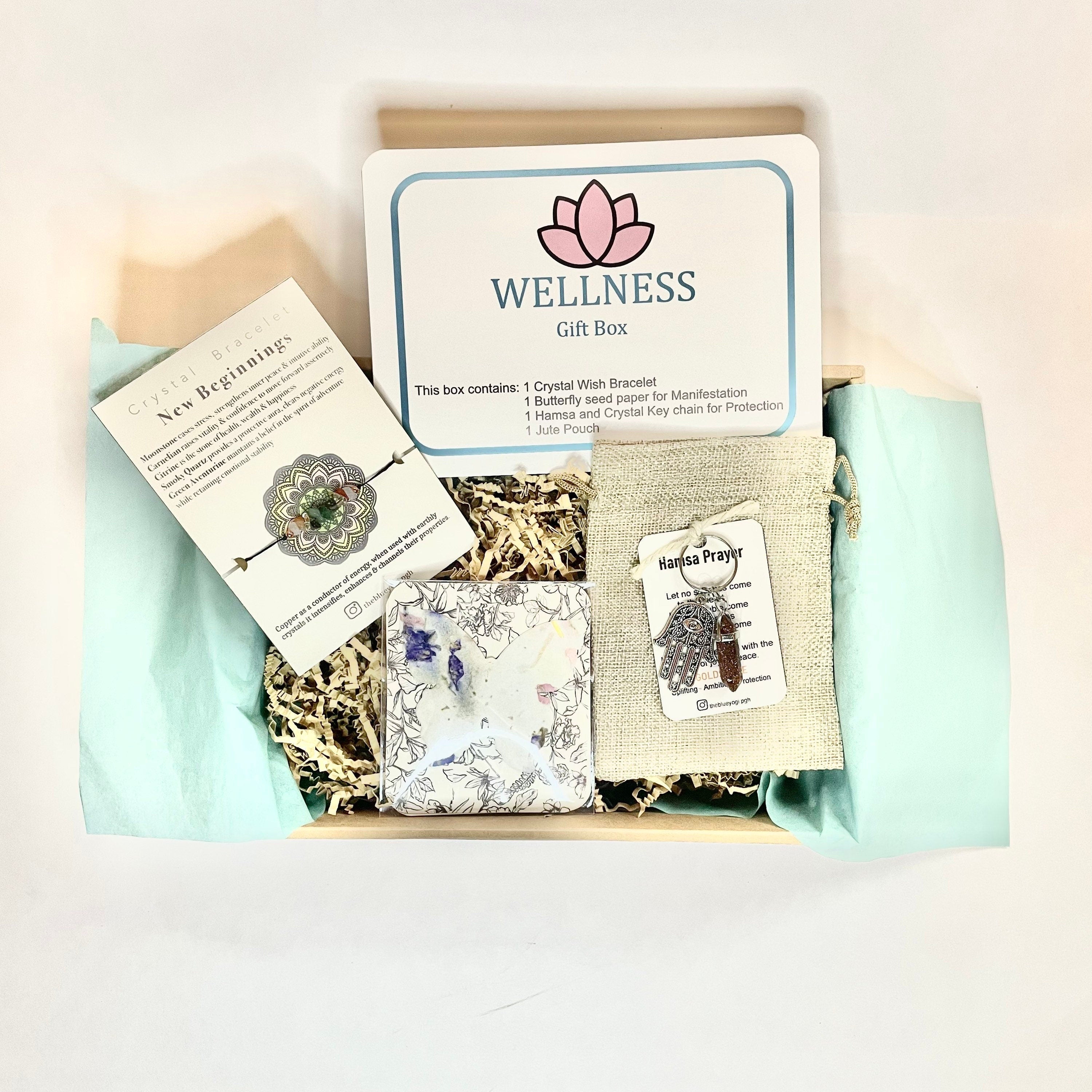 Wellness Gift Box containing a crystal bracelet, keychain, butterfly seed paper, and jute bag, beautifully arranged.