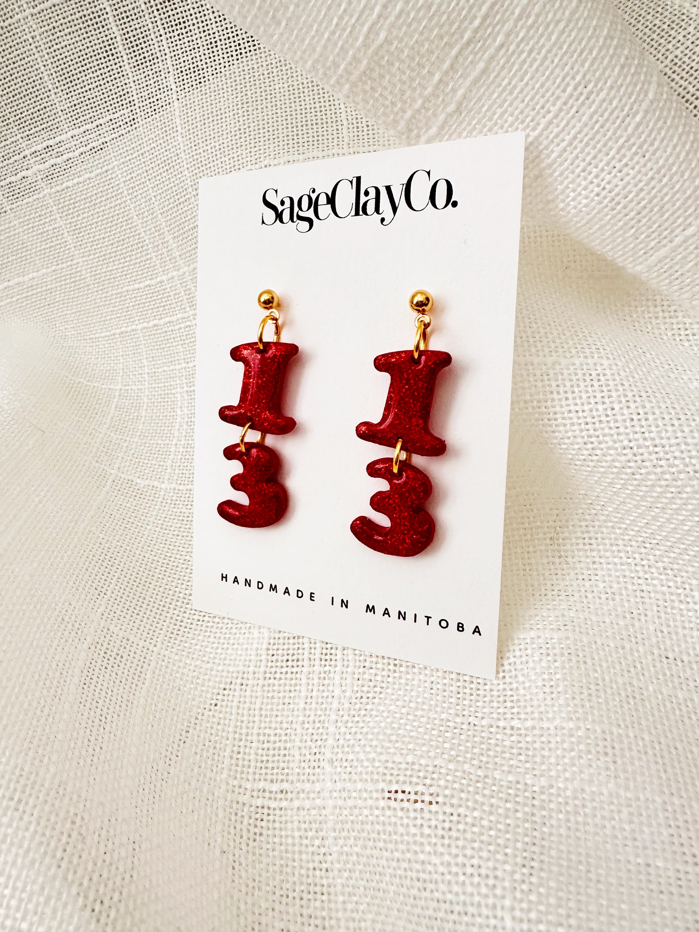 Handmade polymer clay earrings in vibrant TS Red, featuring unique dangle design, lightweight and hypoallergenic for comfortable wear.
