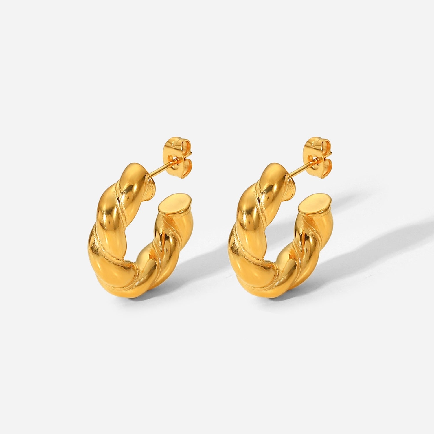 A pair of 23mm large CC shape twisted hoop earrings made of stainless steel, showcasing a unique open design perfect for women.