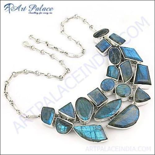 A pair of handcrafted 925 silver earrings featuring checker cut pear lapis gemstones, showcasing their vibrant blue color and unique design.