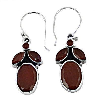 A pair of elegant 925 silver earrings featuring vibrant red onyx gemstones, showcasing intricate craftsmanship and a stylish design.