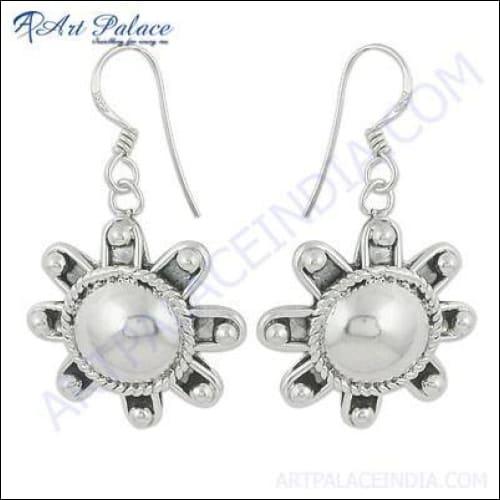 A pair of elegant 925 silver earrings designed by Indian artisans, showcasing intricate patterns and a polished finish.