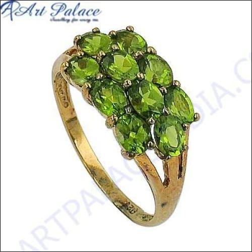A luxurious silver and gold plated ring featuring a vibrant peridot gemstone, showcasing intricate craftsmanship and elegant design.