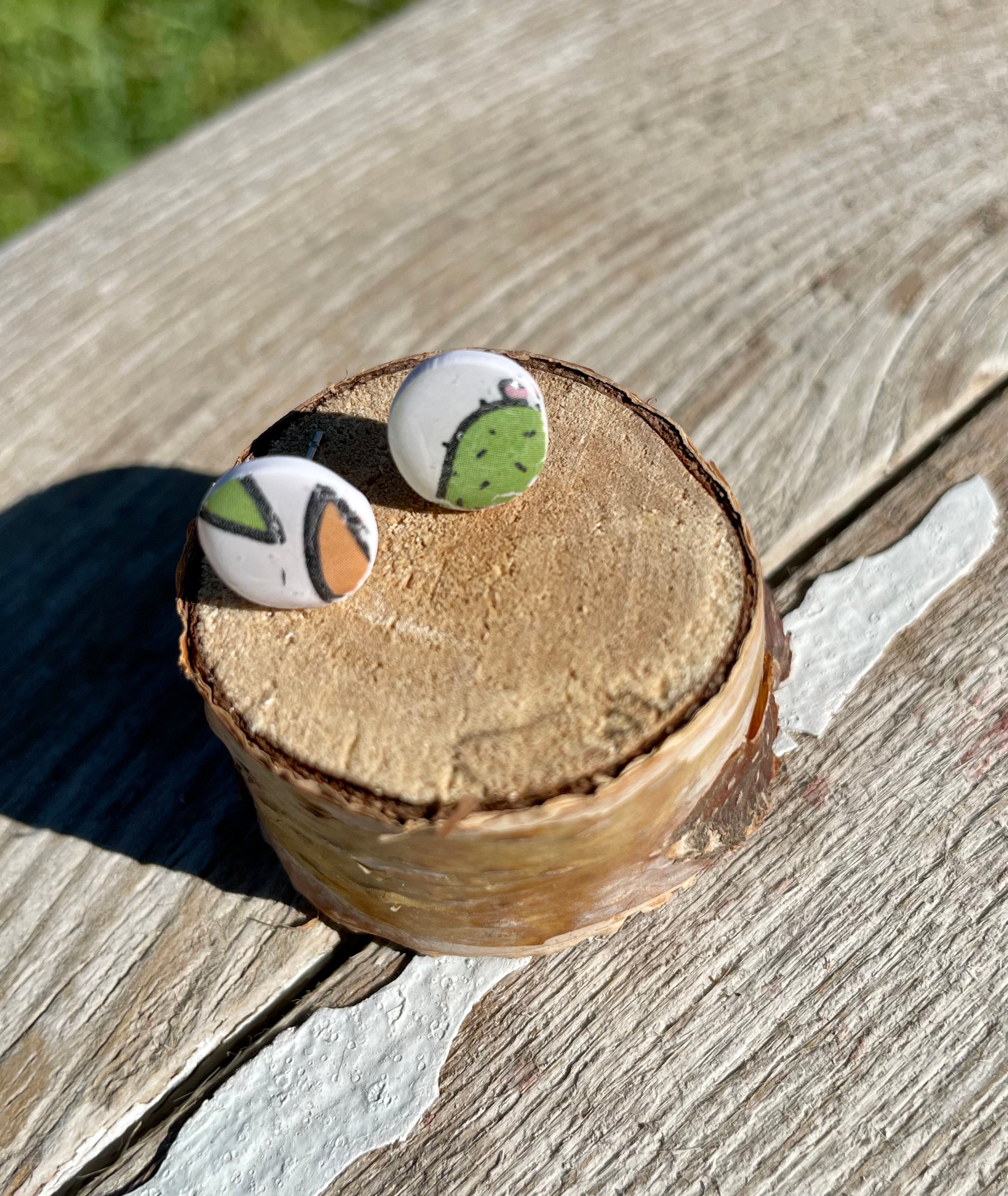 A pair of handmade cactus micro studs earrings featuring unique designs and vibrant colors, crafted in Utah.