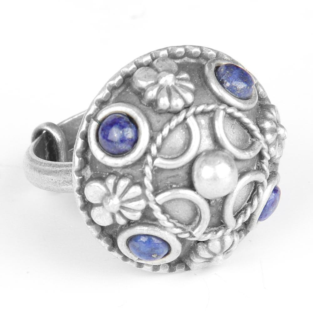A beautifully crafted oxidized silver ring featuring a deep blue Lapis gemstone, showcasing intricate hand-carved designs.