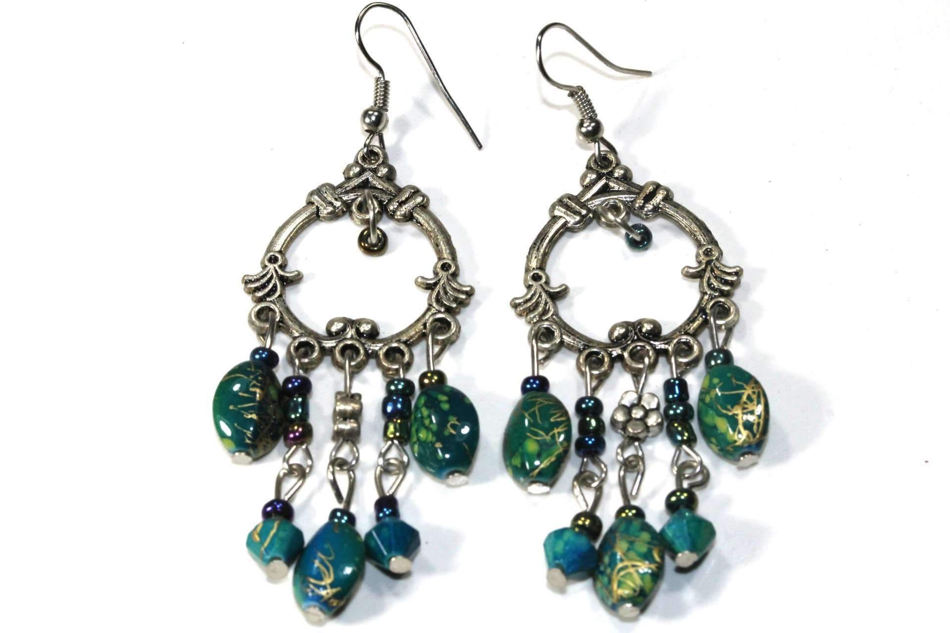 Bohemian chandelier earrings featuring marbled green and turquoise beads with flower charms, showcasing a vibrant and stylish design.