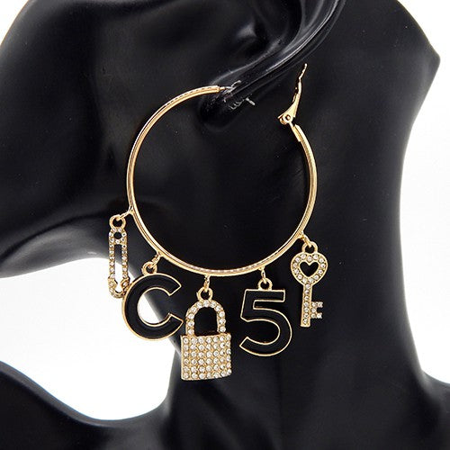 Charm hoop earrings featuring a key and lock design, with a 3-inch drop and latch back closure.