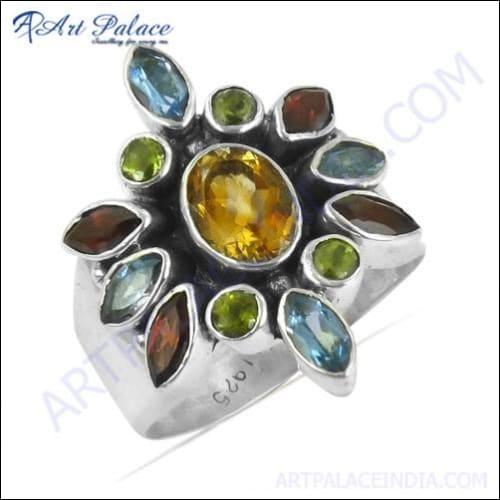 Charming silver ring featuring blue topaz, citrine, garnet, and peridot gemstones, showcasing vibrant colors and elegant design.