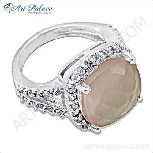 Dazzling silver ring featuring a rose quartz center stone surrounded by cubic zirconia accents, showcasing elegant craftsmanship.