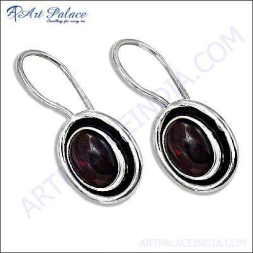 Delicate garnet gemstone silver earrings showcasing intricate design and vibrant red stones, perfect for elegant occasions.