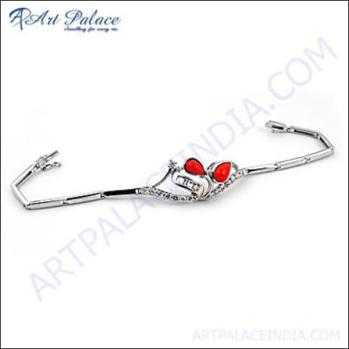 A glamorous silver bracelet featuring cubic zirconia and synthetic coral gemstones, showcasing exquisite craftsmanship and elegant design.