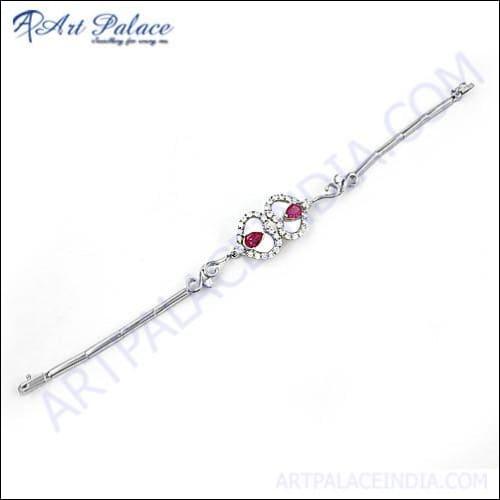 Designer heart-shaped silver bracelet featuring red cubic zirconia gemstones, elegantly crafted for stylish wear.