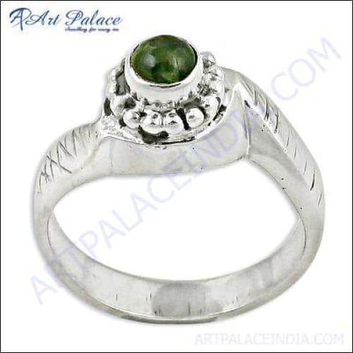 A stunning designer silver ring featuring a vibrant peridot gemstone, showcasing intricate craftsmanship and elegant design.