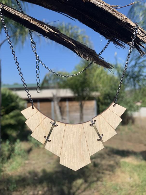 Egyptian Goddess Necklace #6130 featuring laser-cut wood design, adjustable stainless steel chain, and essential oil diffuser functionality.