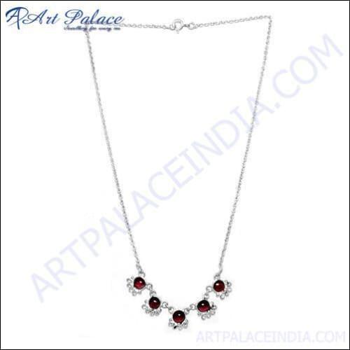 Elegant garnet and silver necklace featuring vibrant red gemstones set on a sleek sterling silver chain, showcasing exquisite craftsmanship.