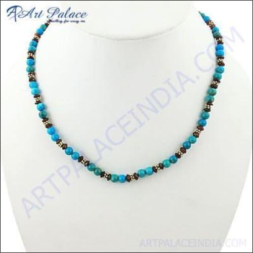 Elegant silver necklace featuring garnet and turquoise gemstones, showcasing intricate craftsmanship and vibrant colors.