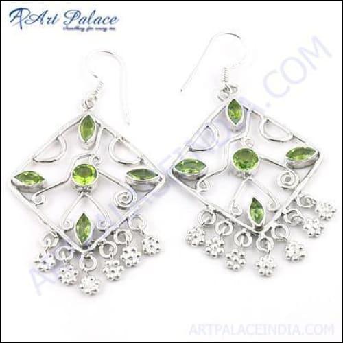 Elegant party wear designer earrings featuring peridot gemstones set in 925 silver, showcasing intricate craftsmanship and a stunning design.