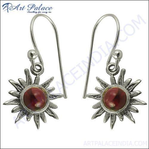 Elegant sun-style earrings featuring garnet stones set in high-quality silver, showcasing intricate craftsmanship.
