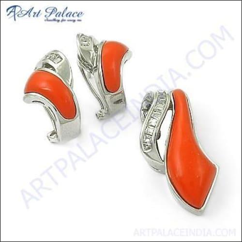 Elegant silver pendant set featuring synthetic coral and cubic zirconia stones, showcasing a vibrant design.