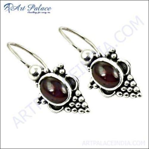 Elegant ethnic designer silver earrings featuring trendy oval garnet gemstones, showcasing intricate craftsmanship and a stunning design.