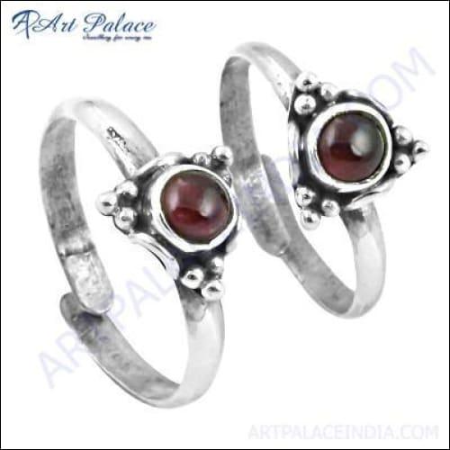 A pair of elegant ethnic silver toe rings featuring vibrant tourmaline stones, showcasing intricate designs.