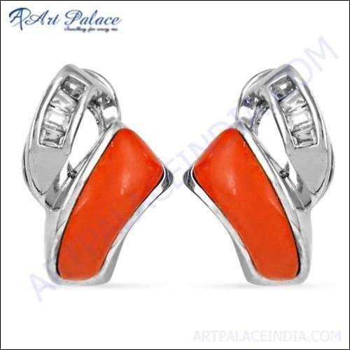 A pair of elegant silver earrings featuring coral cubic zirconia gemstones, showcasing intricate design and craftsmanship.