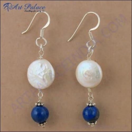 Elegant silver earrings featuring lapis lazuli stones and pearls, showcasing intricate craftsmanship.
