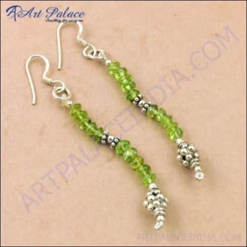Fashionable silver earrings featuring green peridot gemstones and a unique beaded design, perfect for stylish occasions.