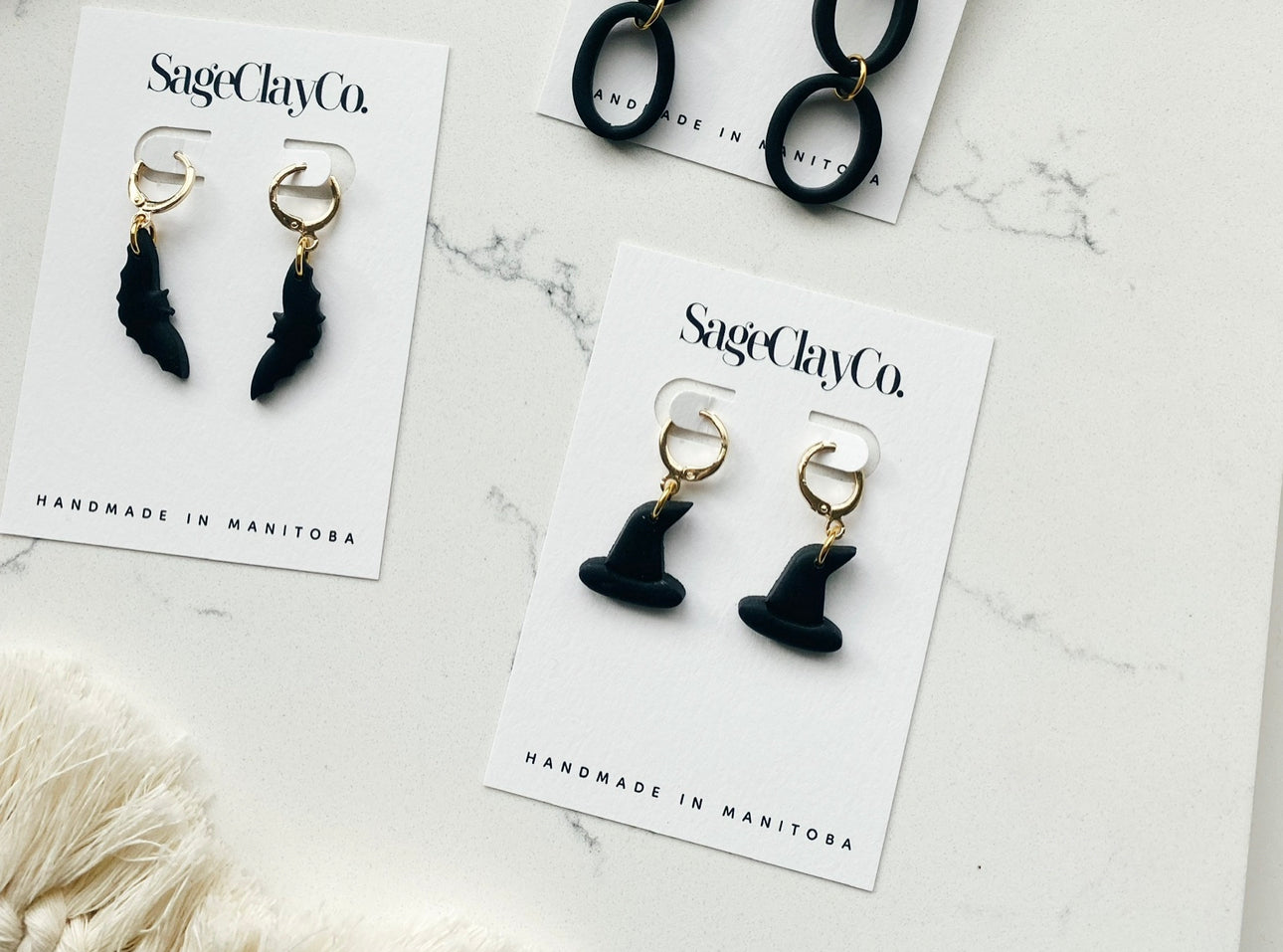 A pair of handmade Halloween Huggie earrings made from polymer clay, featuring unique designs perfect for festive occasions.