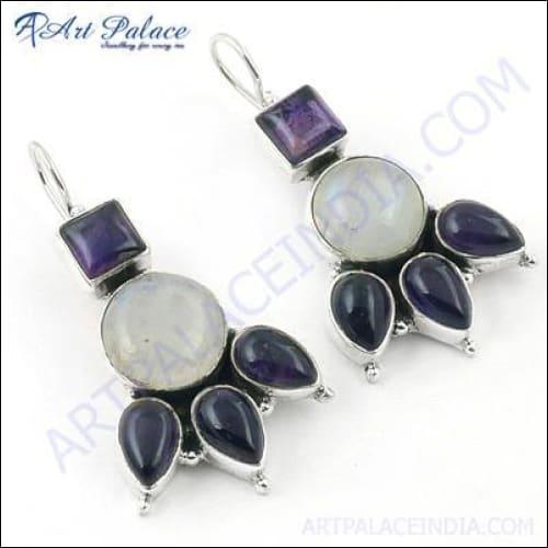 Handcrafted silver earrings featuring amethyst and rainbow moonstone gemstones, showcasing intricate design and craftsmanship.