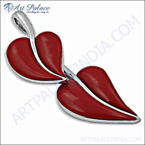 Handcrafted silver pendant featuring a vibrant synthetic coral gemstone, showcasing intricate design and craftsmanship.