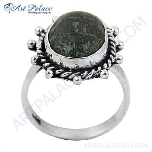 Handcrafted silver ring featuring a unique green turquoise gemstone, showcasing intricate design and craftsmanship.