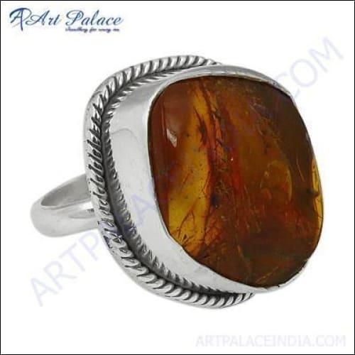 Hand-finished silver ring featuring a stunning opaque amber gemstone, showcasing intricate craftsmanship and elegant design.