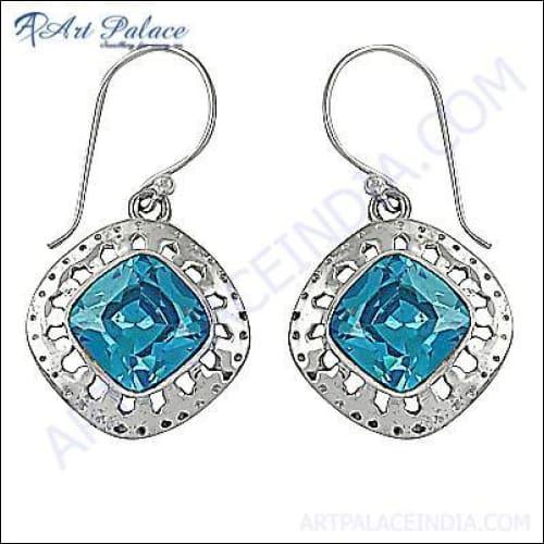 Handmade 925 silver earrings featuring blue cubic zirconia gemstones, showcasing intricate design and craftsmanship.