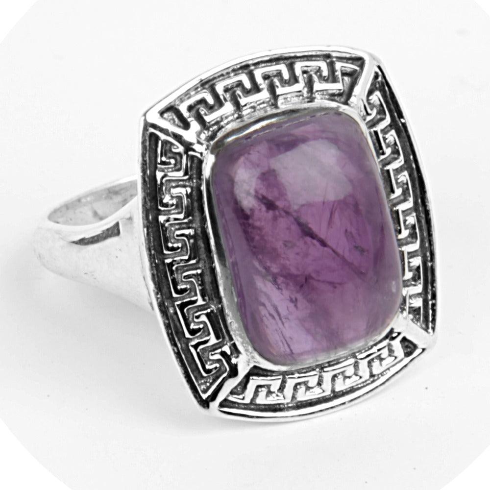 Handmade 925 silver ring featuring a sparkling amethyst gemstone, showcasing intricate craftsmanship and elegant design.