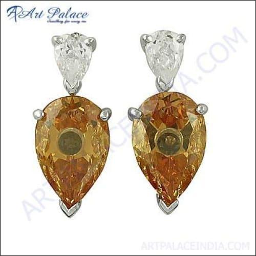 A pair of handmade silver earrings featuring cubic zirconia gemstones, showcasing a unique and elegant design.