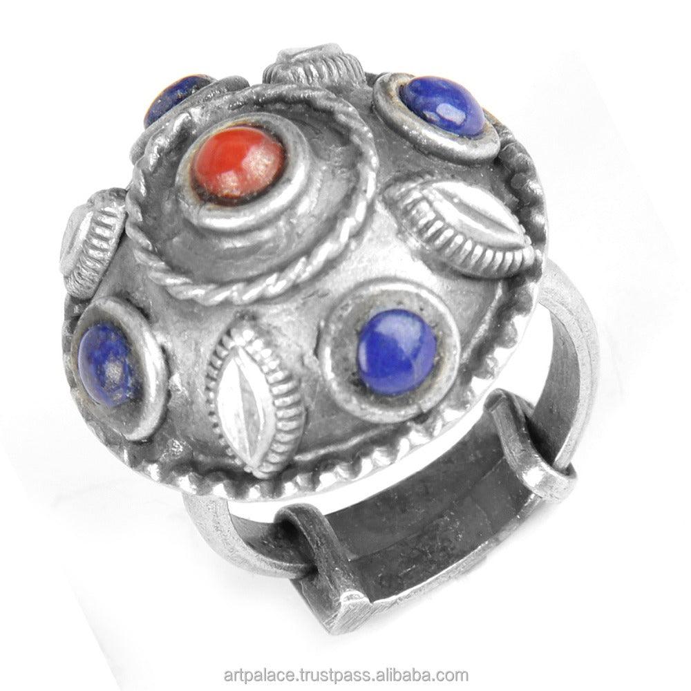 Handmade oxidized silver ring featuring lapis lazuli and coral gemstones, showcasing a vibrant blue and red color combination.
