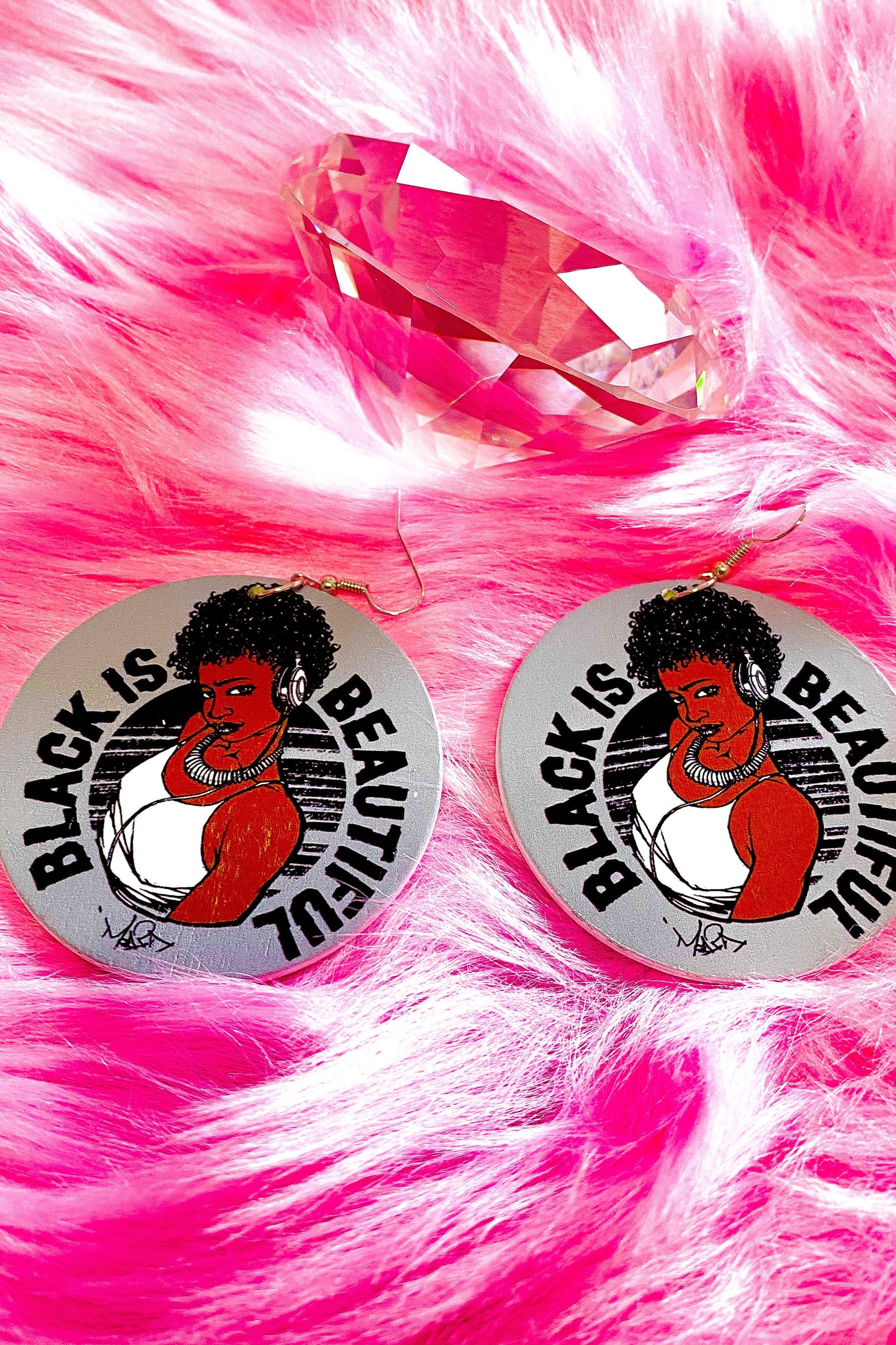 Handmade wooden hoop drop earrings in gray, brown, and black, featuring a unique print repeat design and nickel-free brass ear hooks.