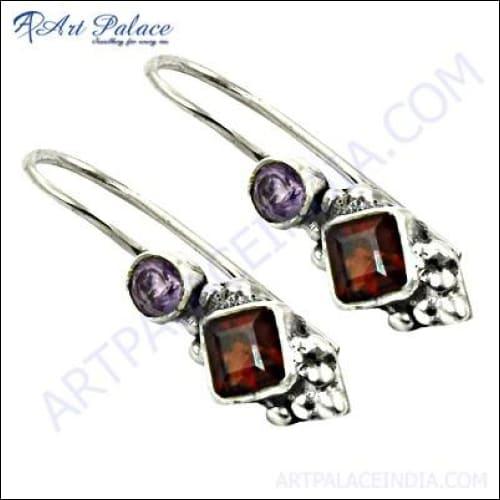 A pair of elegant silver earrings featuring vibrant amethyst garnet gemstones, showcasing intricate craftsmanship and design.