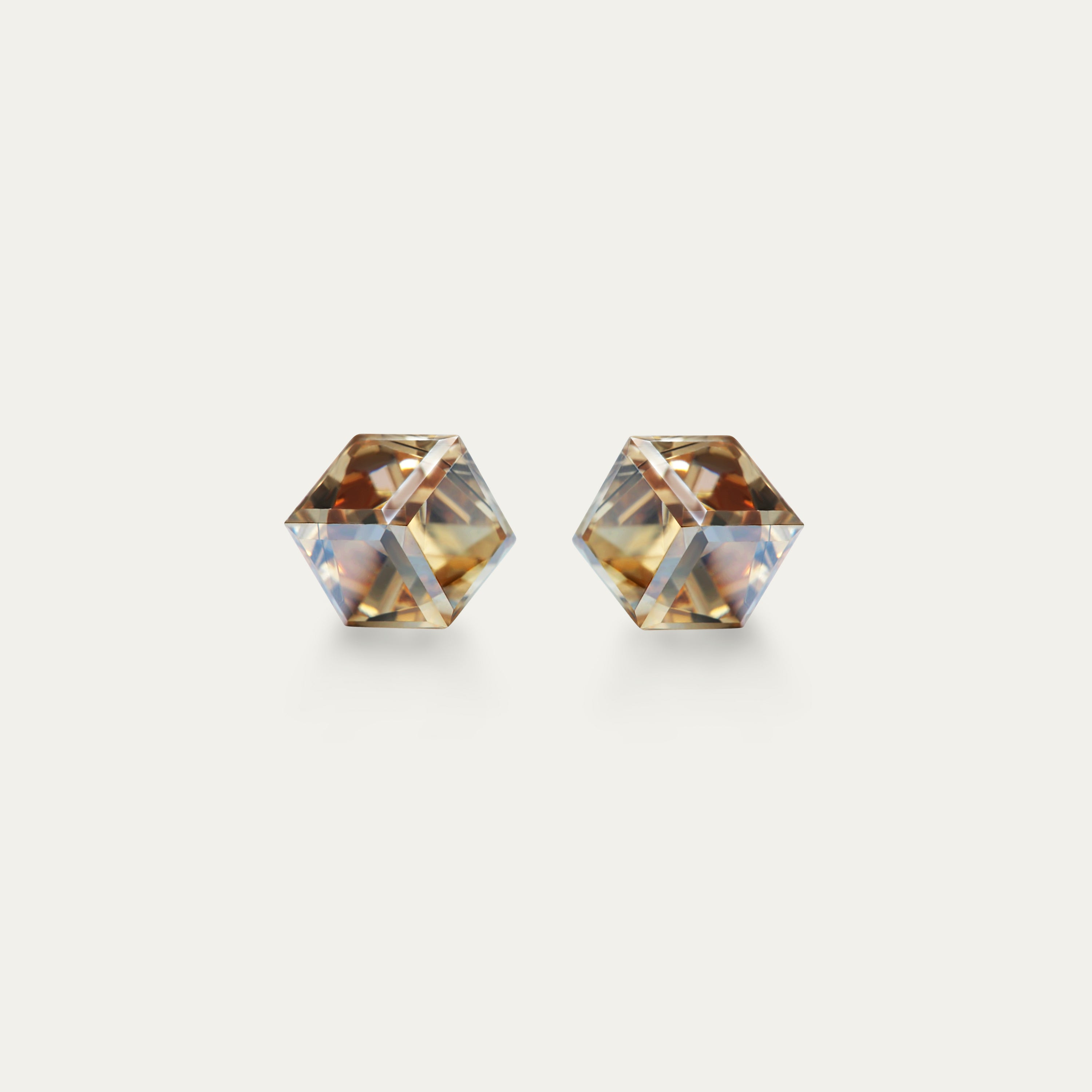 Irene - Golden Shadow earrings featuring 4mm gold color cubic crystals set in hypoallergenic stainless steel, showcasing modern elegance.