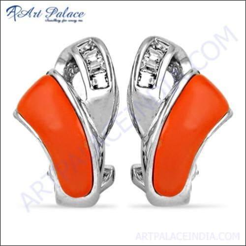 A pair of elegant silver earrings featuring coral cubic zirconia gemstones, showcasing intricate design and craftsmanship.