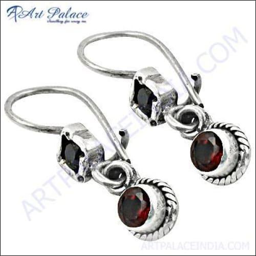 A pair of elegant ethnic garnet gemstone earrings with a simple design, showcasing their vibrant red color and fine craftsmanship.