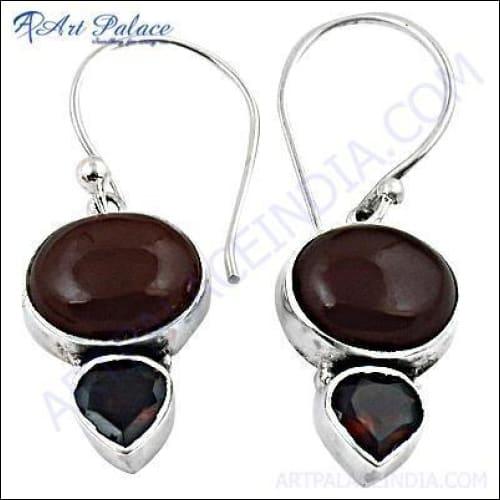 A pair of luxurious garnet red onyx silver earrings, showcasing intricate design and vibrant color.