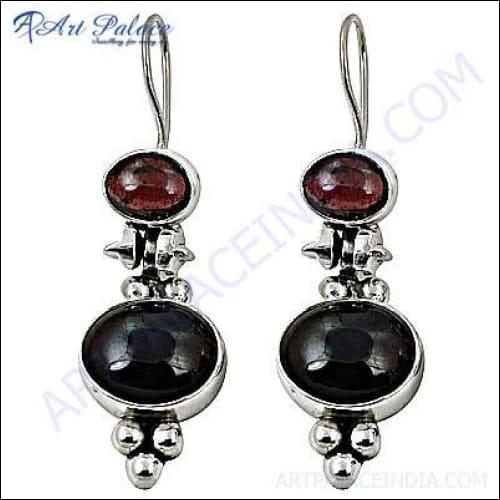 Elegant silver dangle earrings featuring natural garnet gemstones, showcasing a sophisticated design perfect for any occasion.